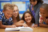 kids reading a book together